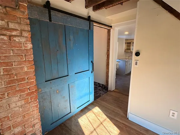 a view of hallway with wooden floor