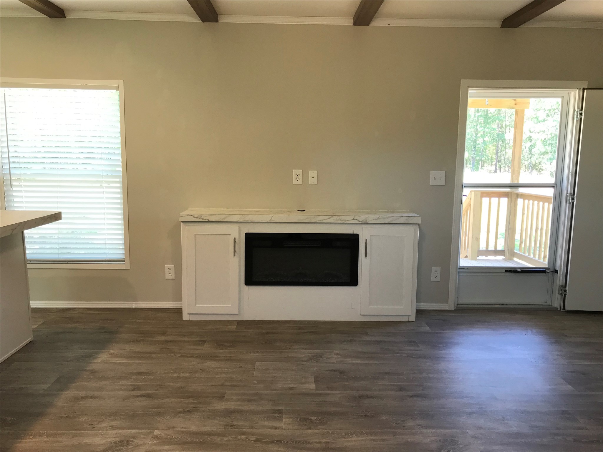 246 Brenda Road Trinity, TX 75862 - Photo 23 of 28 a view of an empty room with wooden floor and a window
