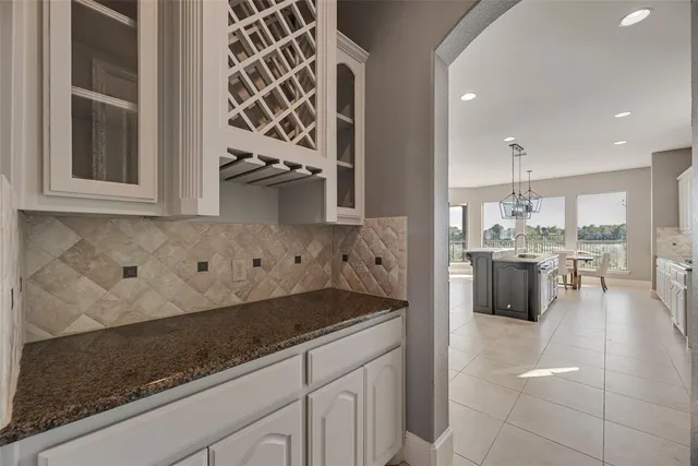 a kitchen with a stove and a white cabinets