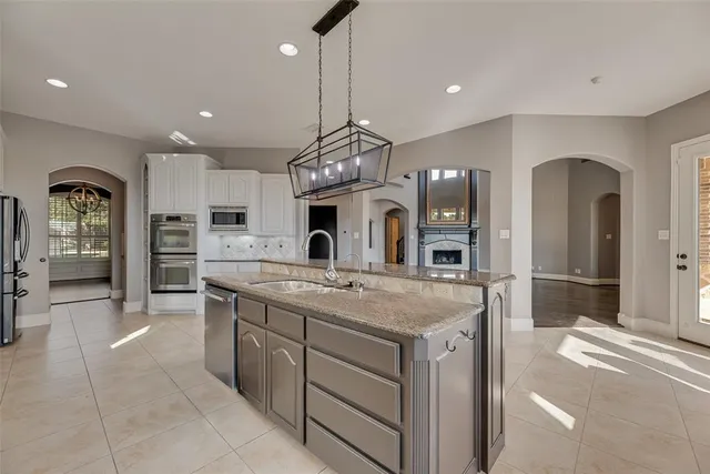 a kitchen with stainless steel appliances granite countertop a sink and stove