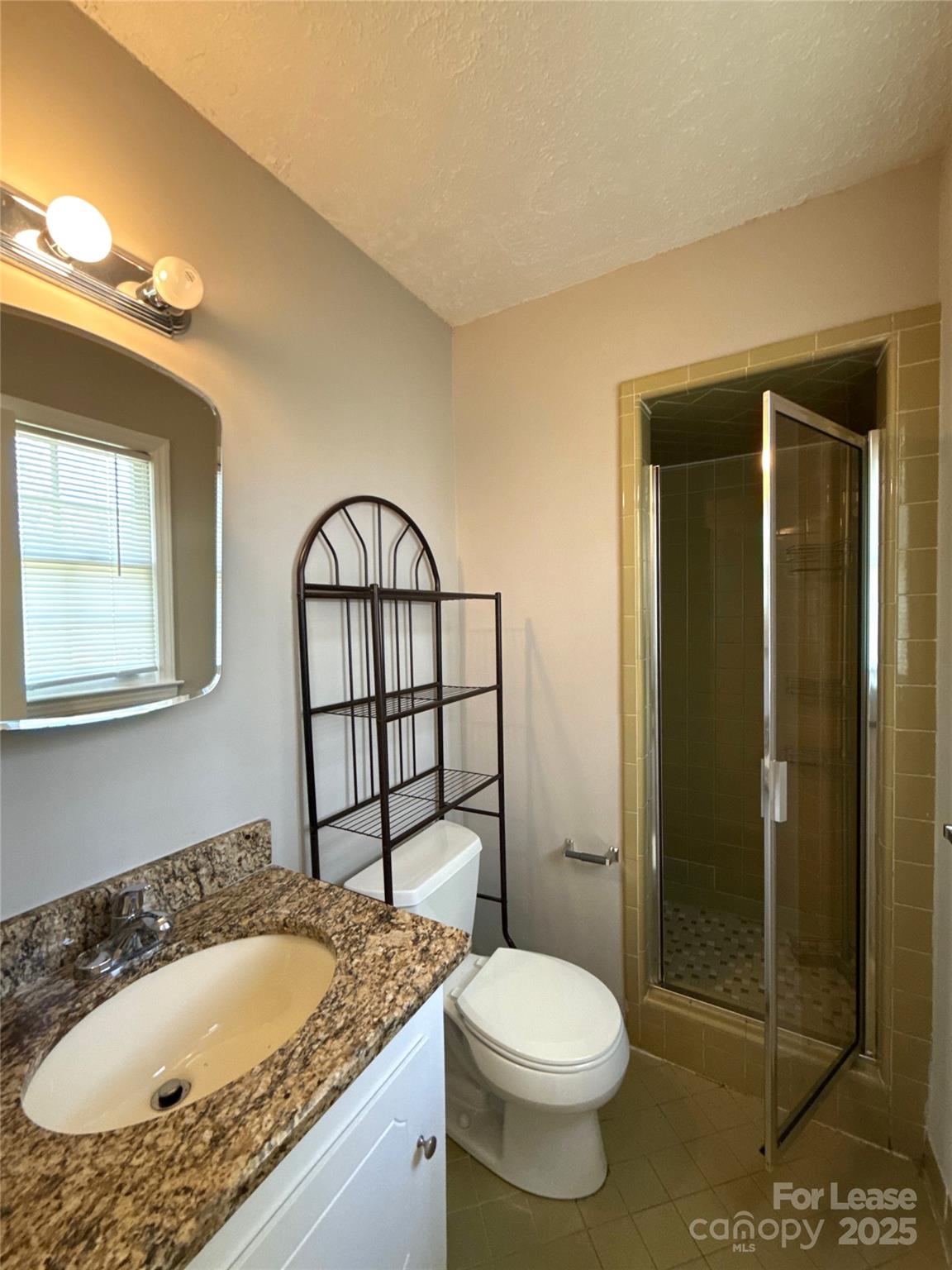 906 McLaughlin Drive Charlotte, NC 28212 - Photo 17 of 21 a bathroom with a granite countertop sink a toilet and shower