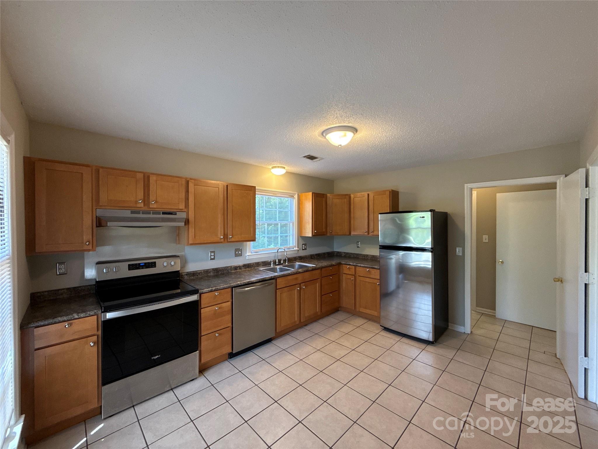 906 McLaughlin Drive Charlotte, NC 28212 - Photo 10 of 21 a kitchen with a sink and stainless steel appliances
