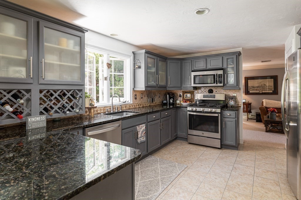 51 Davis Street Northborough, MA 01532 - Photo 4 of 35 a kitchen with a stove a sink and a microwave