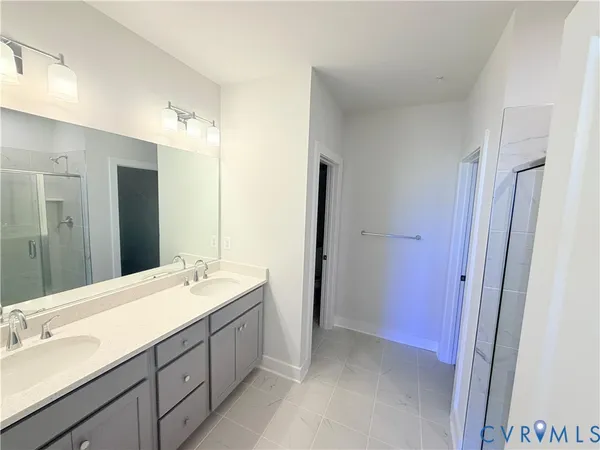 a bathroom with a double vanity sink mirror double and shower