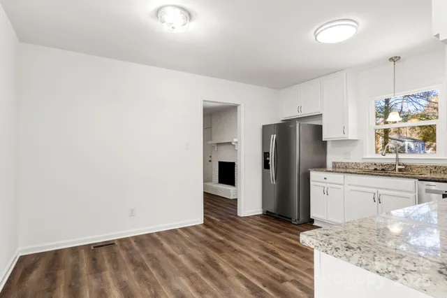 a kitchen with a refrigerator and a sink