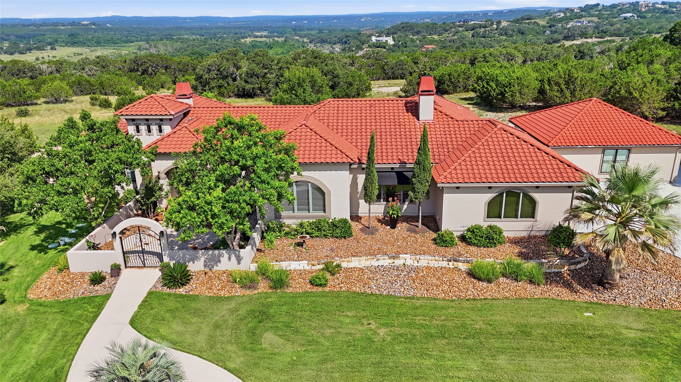 228 Puzzle Pass Spring Branch, TX 78070 - Photo 2 of 35 A striking blend of timeless architecture, curated landscaping, and panoramic Hill Country views.