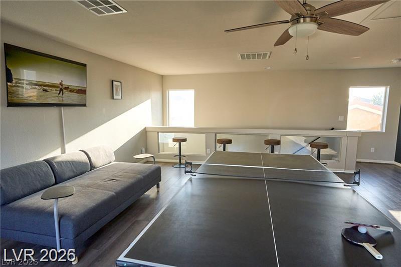 6302 Jackson Spring Road Las Vegas, NV 89118 - Photo 33 of 48 A well-lit recreational loft space with a ping pong table and bar seating offers engaging entertainment.