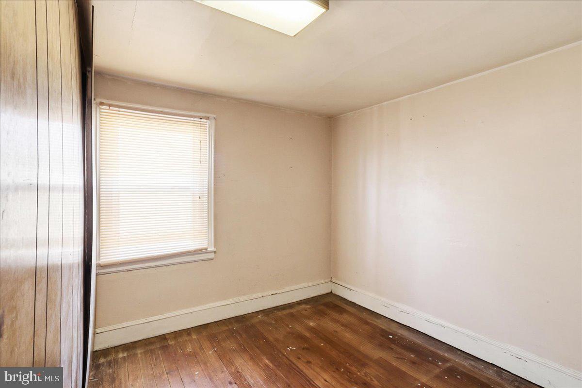 966 Upper Gulph Road Wayne, PA 19087 - Photo 11 of 23 a view of an empty room with wooden floor and a window