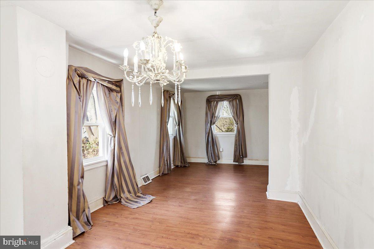 966 Upper Gulph Road Wayne, PA 19087 - Photo 9 of 23 wooden floor in an empty room with a window
