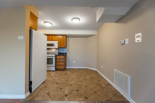 a view of a kitchen with a sink and a refrigerator