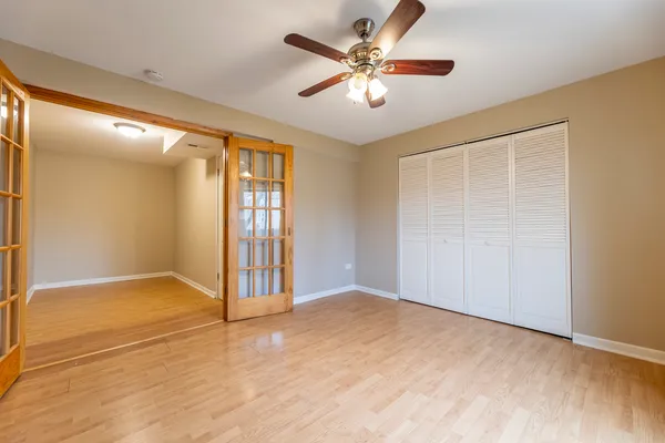 an empty room with fan and entrance