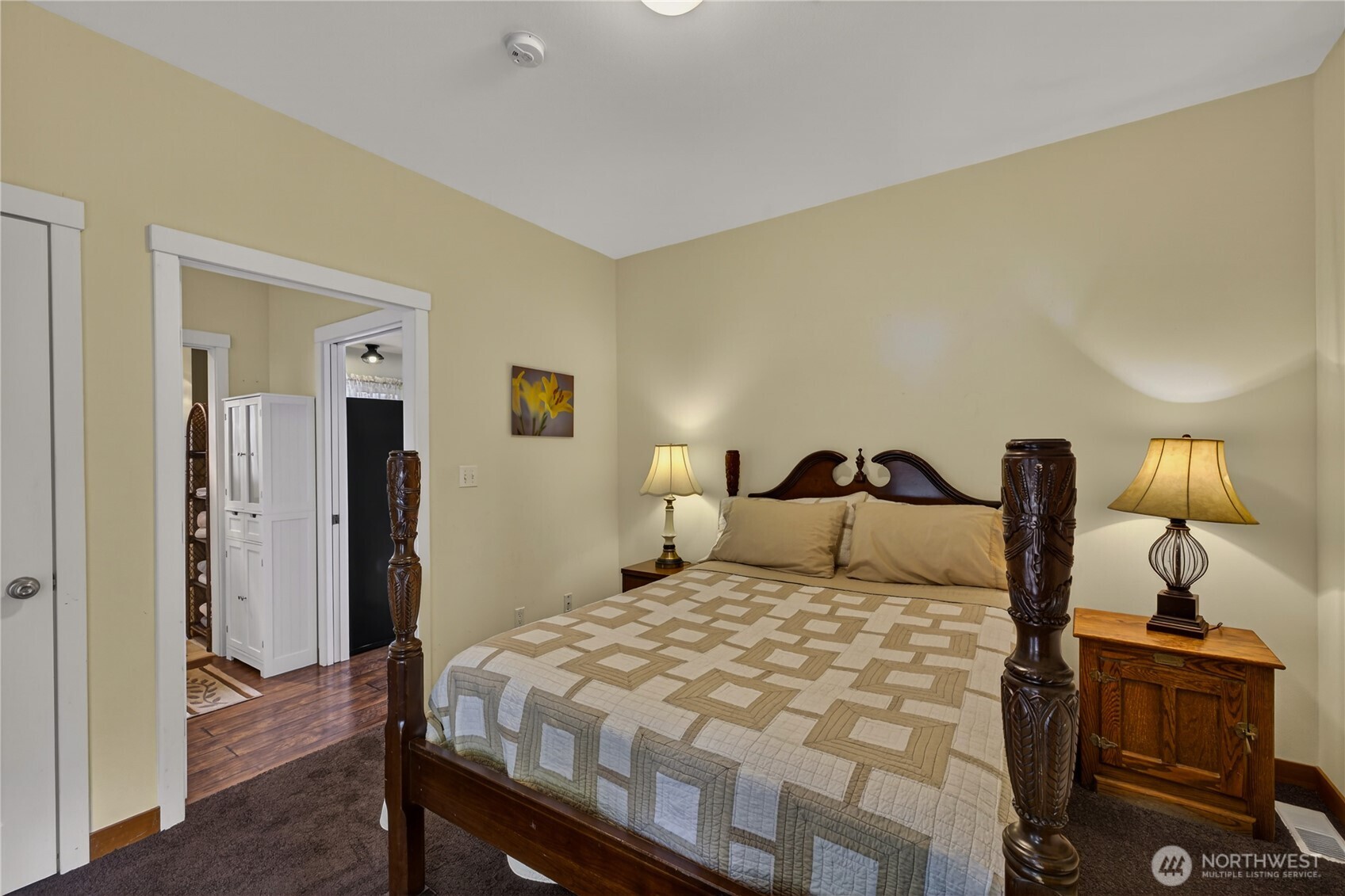 17946 Cobahud Road La Conner, WA 98257 - Photo 27 of 40 a bedroom with a bed and wooden floor