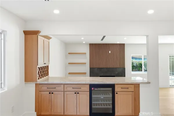 a kitchen with a sink and a large mirror