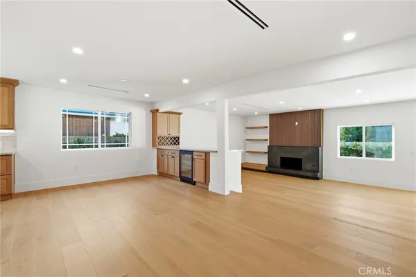 an empty room with a fireplace and window