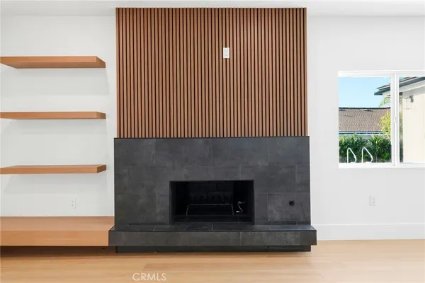 a living room with a fireplace furniture and a window