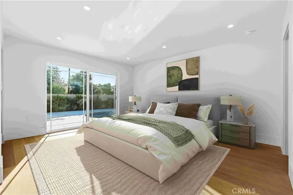 a bedroom with a large bed and a large window