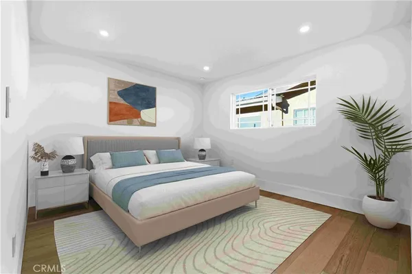 a bedroom with a large bed and a painting on the wall