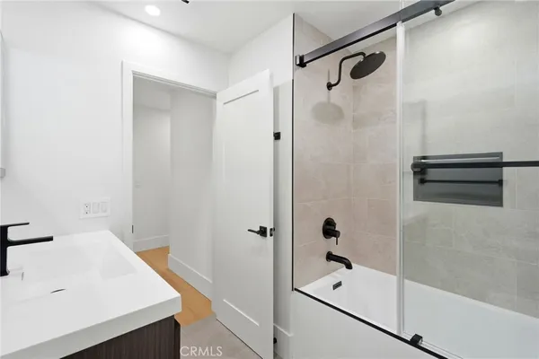 a bathroom with a sink a shower and a mirror