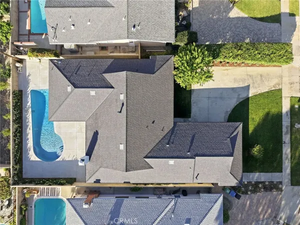 an aerial view of a house with a yard and large space