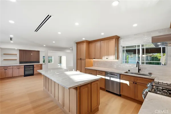 a kitchen with stainless steel appliances sink stove microwave and cabinets