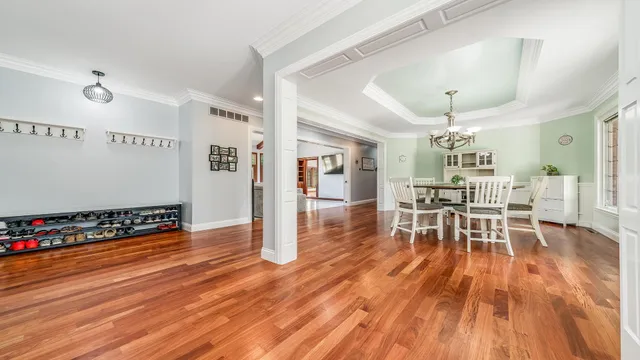 a view of a livingroom with furniture wooden floor and chandelier