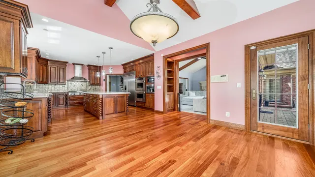 a spacious bedroom with a bed and a flat screen tv