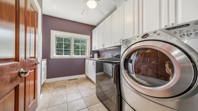 a spacious bedroom with a bed and ceiling fan