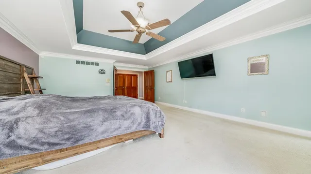 a bedroom with a bed and a chandelier