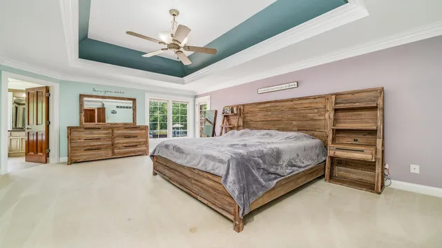 a bedroom with a bed and a chandelier