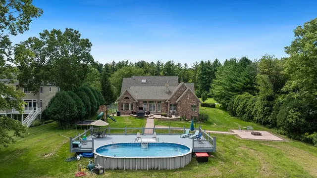 a aerial view of a house with swimming pool and big yard