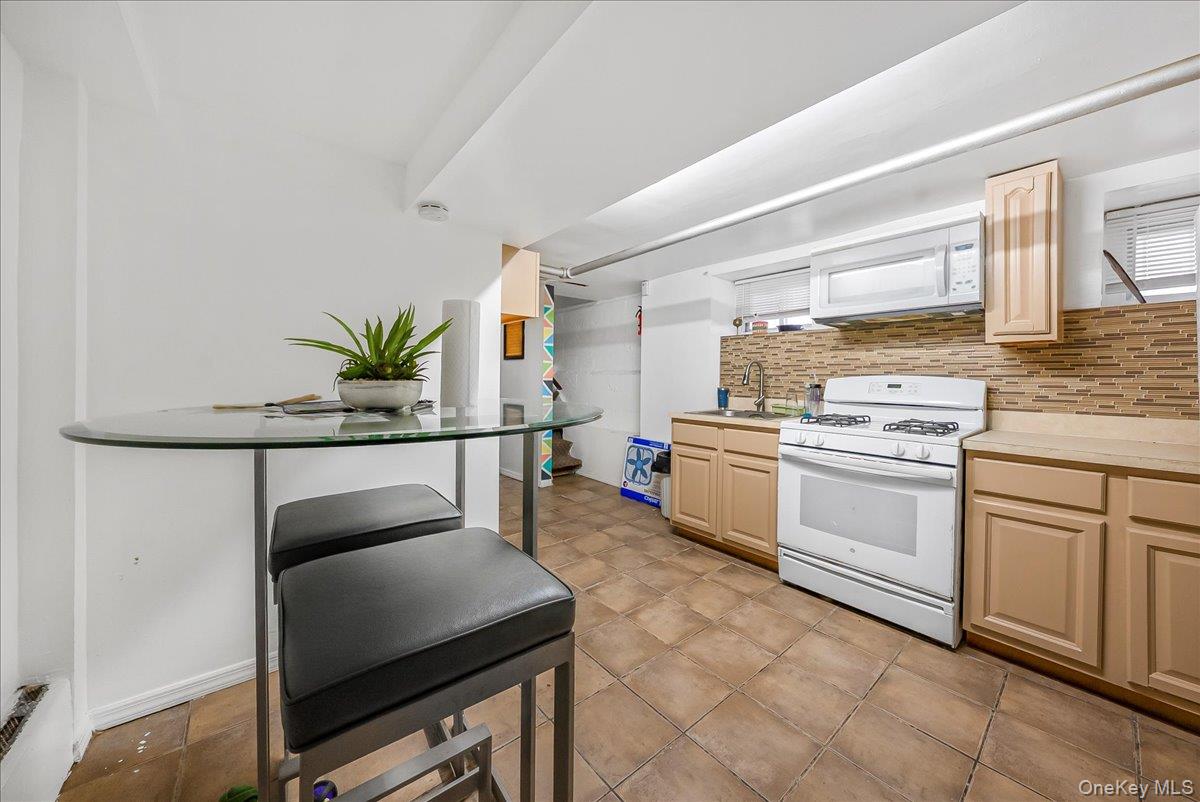 144-35 158th Street Queens, NY 11434 - Photo 11 of 16 a kitchen with white cabinets and white appliances