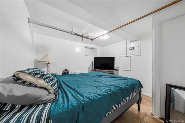 a bedroom with a bed and a television