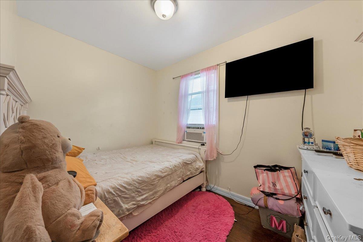 144-35 158th Street Queens, NY 11434 - Photo 9 of 16 a bedroom with a bed and a flat tv screen on the dresser