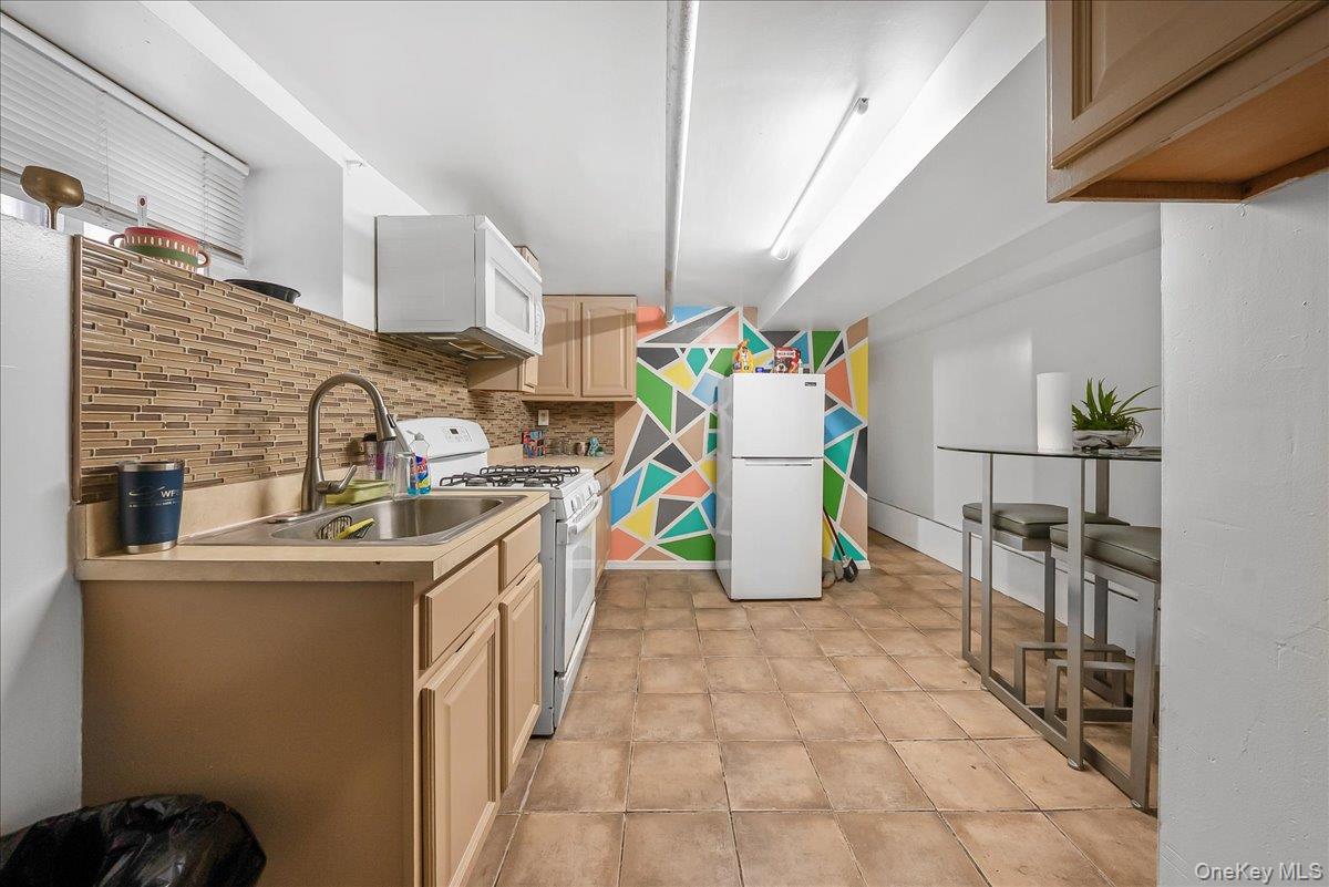 144-35 158th Street Queens, NY 11434 - Photo 10 of 16 a kitchen with a sink appliances and cabinets