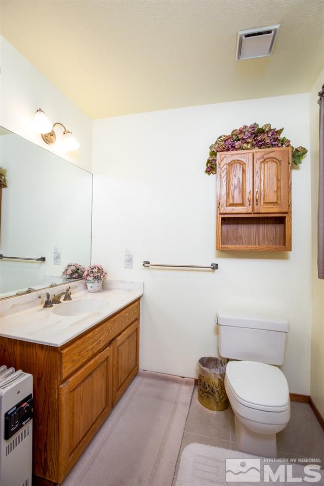 1719 Sunrise Pass Road Minden, NV 89423 - Photo 12 of 39 a bathroom with a sink toilet and mirror