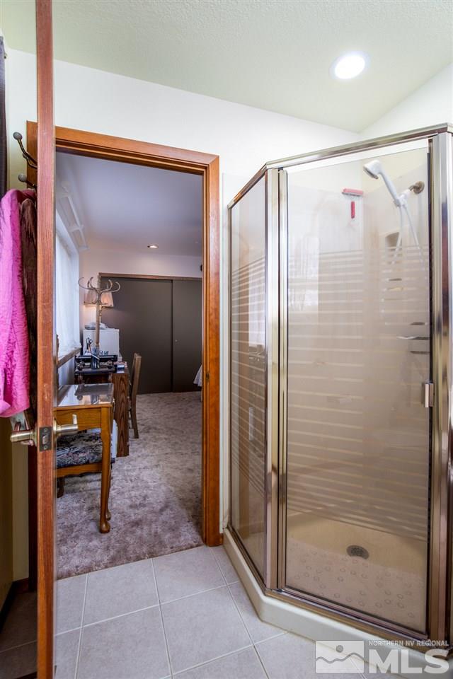 1719 Sunrise Pass Road Minden, NV 89423 - Photo 13 of 39 a bathroom with a shower a mirror and a sink