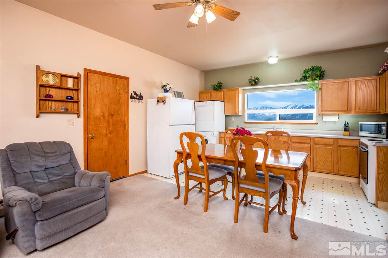 1719 Sunrise Pass Road Minden, NV 89423 - Photo 14 of 39 a living room with furniture a chandelier and a dining table