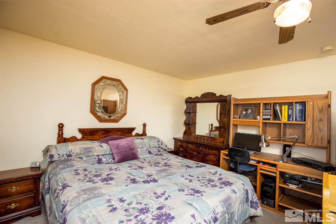 1719 Sunrise Pass Road Minden, NV 89423 - Photo 16 of 39 a bedroom with a bed a dresser and book shelf