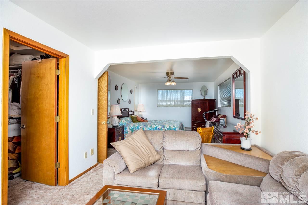 1719 Sunrise Pass Road Minden, NV 89423 - Photo 20 of 39 a living room with patio furniture and a large window