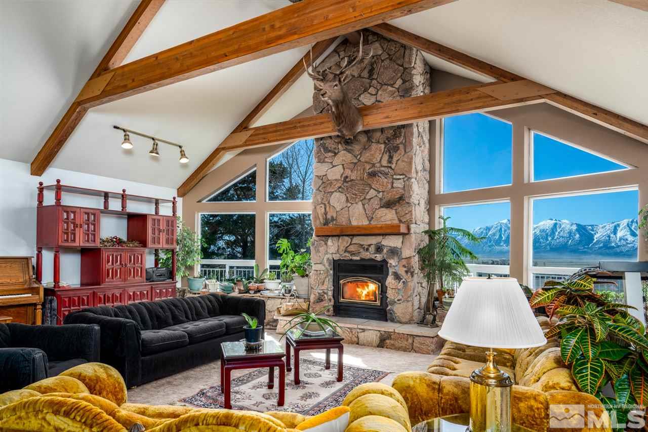 1719 Sunrise Pass Road Minden, NV 89423 - Photo 2 of 39 a living room with furniture a fireplace and a ceiling fan