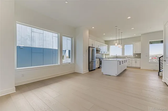 a kitchen with stainless steel appliances a refrigerator sink and cabinets