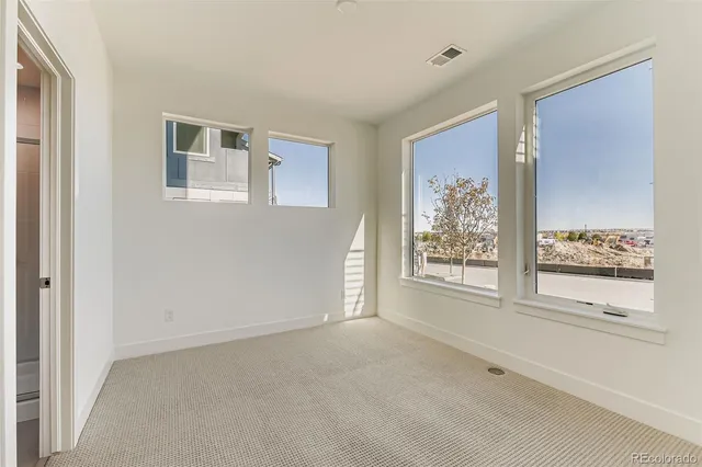 a view of a big room with windows and chandelier
