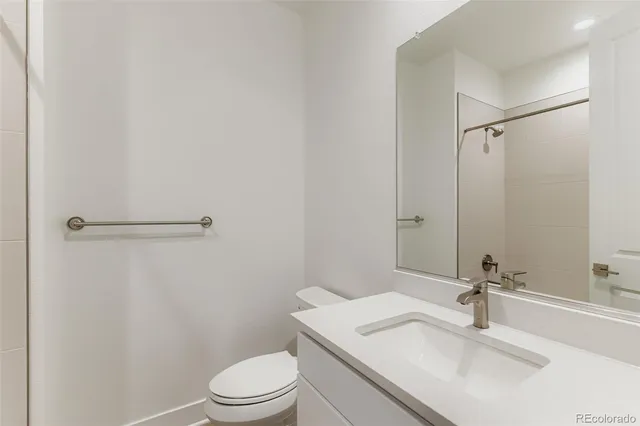 a bathroom with a sink toilet and a mirror