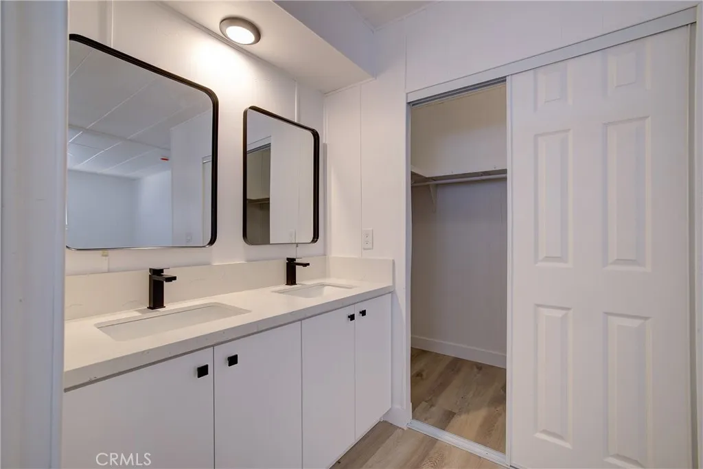3700 Buchanan Street, Unit 164 Riverside, CA 92503 - Photo 31 of 40 a bathroom with a double vanity sink and mirror