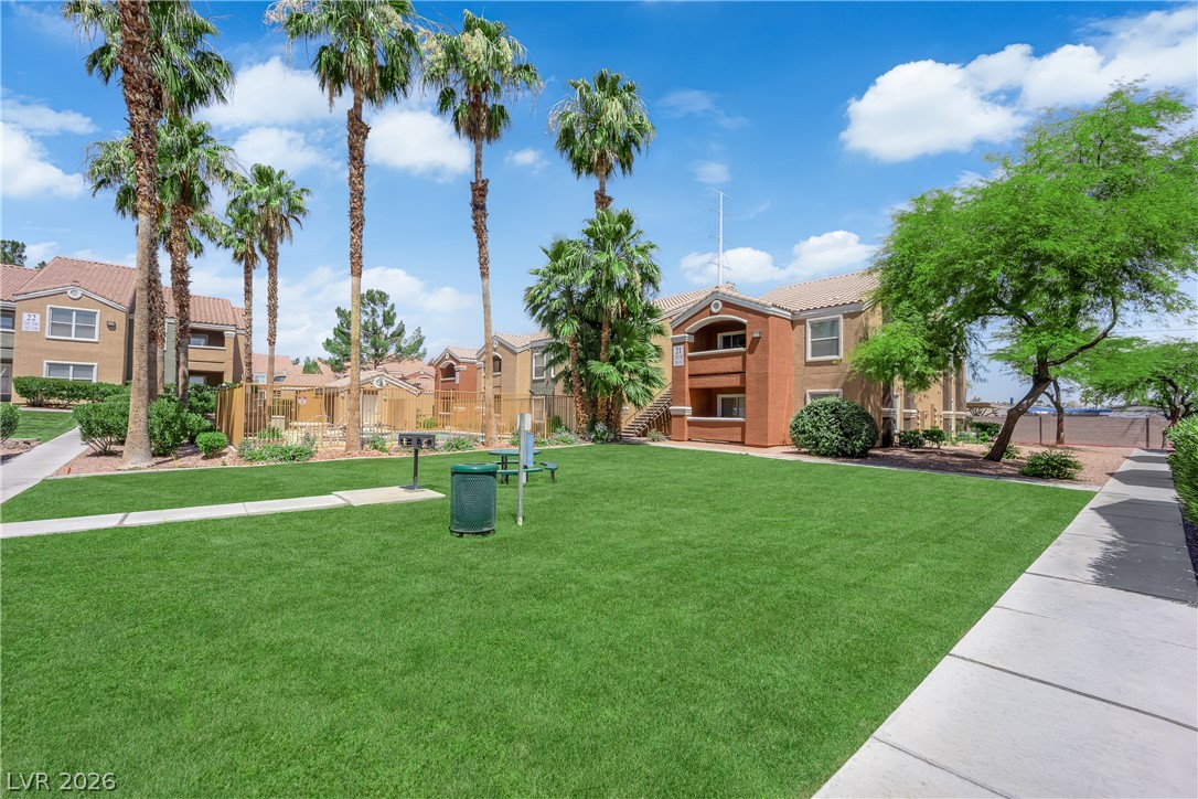 8101 West Flamingo Road, Unit 2030 Las Vegas, NV 89147 - Photo 2 of 27 A vibrant green lawn and swaying palm trees provide a welcoming oasis for residents.