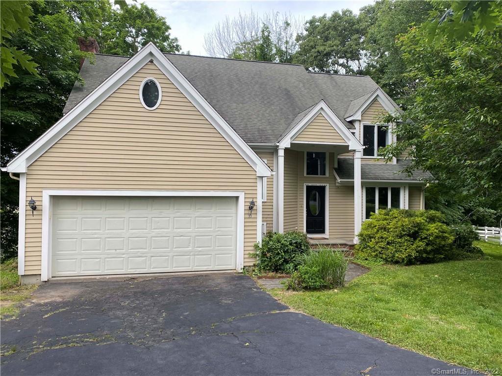 10 Titus Place Ridgefield, CT 06877 - Photo 1 of 1 a front view of a house with a yard and garage