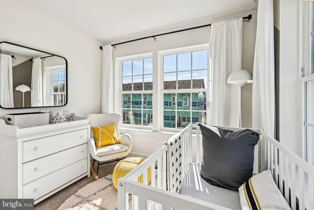 a view of a bedroom with furniture window and wooden floor