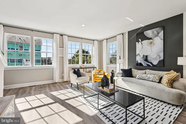 a living room with furniture and next to a window
