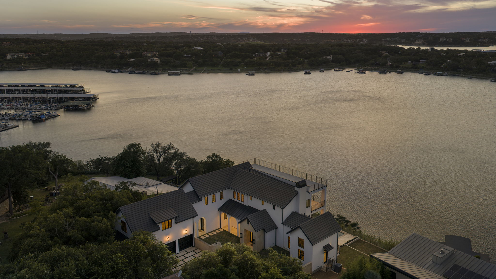 1496 Buffalo Gap Road Lakeway, TX 78734 - Photo 2 of 37 Perched above the lake, this elegant residence offers panoramic water views and a private boat dock.