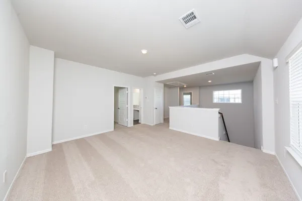a view of a big room with closet and windows